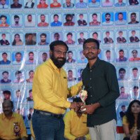 Faculty sir presenting an award to a student during the testimonials ceremony at Everest Coaching Point. Faculty sir giving award to student during testimonials event at Everest Coaching Point