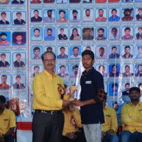 English Sir presenting an award to a student during the testimonials event at Everest Coaching Point. English Sir giving award to student during testimonials event at Everest Coaching Point