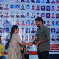 A faculty member presenting an award to a student during the testimonials ceremony at Everest Coaching Point. Faculty member giving award to student during testimonials event at Everest Coaching Point