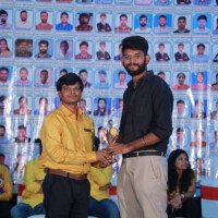 A faculty member awarding a student during the testimonials ceremony at Everest Coaching Point. Faculty member giving award to student during testimonials event at Everest Coaching Point