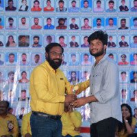 Faculty sir presenting an award to a student during the testimonials ceremony at Everest Coaching Poin Faculty sir giving award to student during testimonials event at Everest Coaching Point