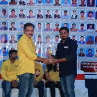 Maths Sir presenting an award to a student during the testimonials ceremony at Everest Coaching Point. Maths Sir giving award to student during testimonials event at Everest Coaching Point