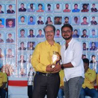 English Sir presenting an award to a student during the testimonials event at Everest Coaching Point. English Sir giving award to student during testimonials event at Everest Coaching Point