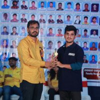 Rajkumar Sir presenting an award to a student during the testimonials ceremony at Everest Coaching Point. Rajkumar Sir giving award to student during testimonials event at Everest Coaching Point