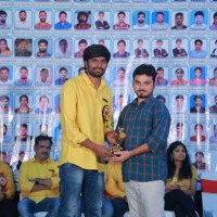 A faculty member presenting an award to a student during the testimonials ceremony at Everest Coaching Point Faculty member giving award to student during testimonials event at Everest Coaching Point