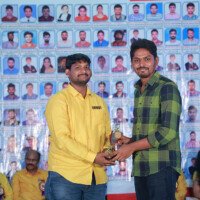 The faculty sir presents an award to another student during the testimonials event at Everest Coaching Point. Faculty sir giving award to another student during testimonials event at Everest Coaching Point