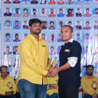 Faculty sir presenting an award to a job holder during the testimonials event at Everest Coaching Point. Faculty sir giving award to job holder during testimonials event at Everest Coaching Point