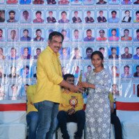 Maths faculty member awarding a student during the testimonials event at Everest Coaching Point. Maths Sir giving award to student during testimonials event at Everest Coaching Point