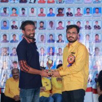 Maths faculty member presenting an award to a student during the testimonials event. Maths Sir giving award to student during testimonials event at Everest Coaching Point
