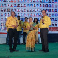 Director Srinivasulu Reddy Sir and Jain Sir jointly presenting an award to a woman during the testimonials event. Director Srinivasulu Reddy Sir and Jain Sir giving award to woman during testimonials event at Everest Coaching Point