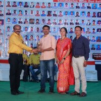 Director Srinivasulu Reddy Sir presenting awards to a student and a faculty member during the testimonials ceremony. Director Srinivasulu Reddy Sir giving award to student and faculty during testimonials event at Everest Coaching Point