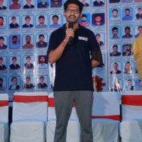 A student shares their experience on stage during the testimonials session. Student giving speech on stage during testimonials event at Everest Coaching Point