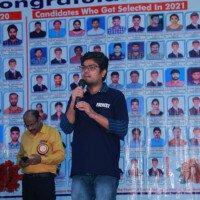 An enthusiastic student sharing insights during a speech – photo gallery highlight. Student confidently giving a speech on stage, featured in the photo gallery.