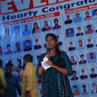 An inspiring student speaking confidently during a speech – photo gallery highlight. Girl delivering a speech on stage, featured in the photo gallery.