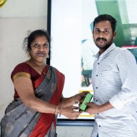 Everest Coaching Point faculty awarding a top-performing student Faculty presenting award to student – testimonials of achievement