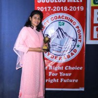 Testimonial – Student Standing with Award Student testimonial with award – Standing pose at Everest Coaching Point