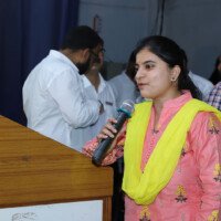 Student delivering speech after achieving success through Everest Coaching Point Successful student giving speech – testimonials of hard work and achievement