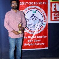 A proud student holding an award at Everest Coaching Point Student with award at Everest Coaching Point – testimonials of achievement