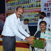 Director Srinivas Lulu Sir giving an award during ceremony Director Sir presenting award – testimonials of recognition and success