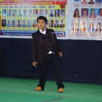 A young student of Everest Coaching Point performing a dance on stage Small kid dancing on stage – testimonials of early talent and joy